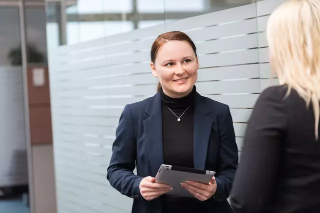 Voith employees with tablet, networking.